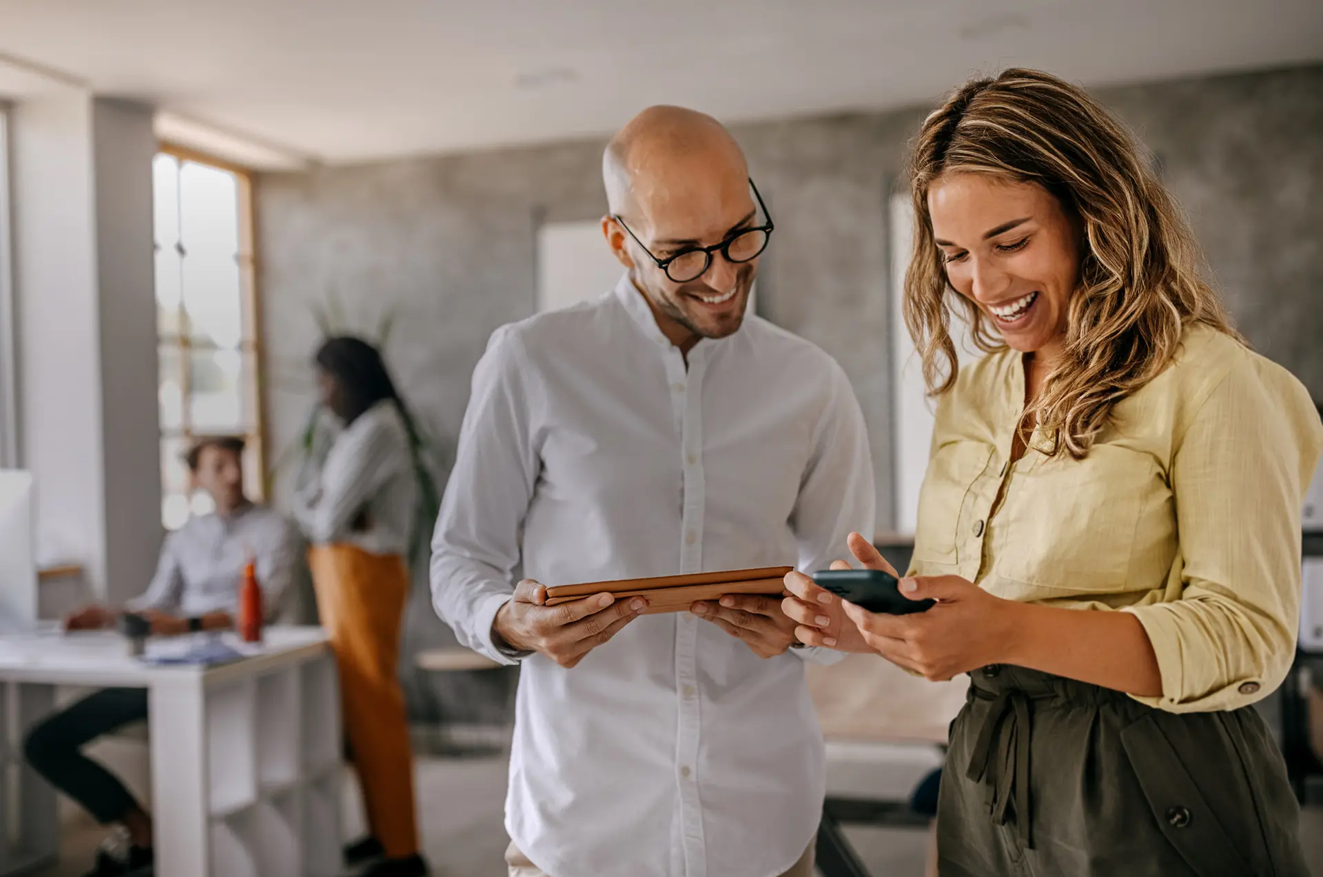 Leerink Partners Articles - Man and woman in an office reading the latest articles on a tablet